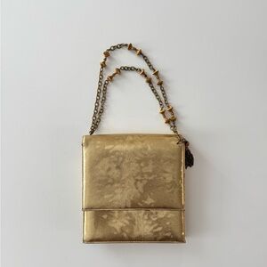 Elegant gold handbag with chains.